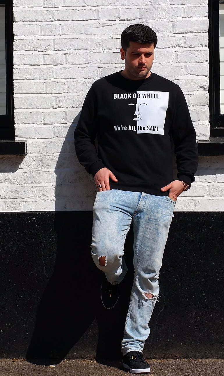 Enis, founder of Unity States, wearing the BLACK OR WHITE sweatshirt